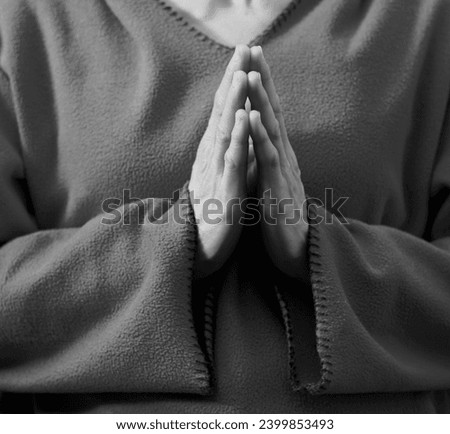 praying to god with hands together woman praying with grey background with people stock image stock photo