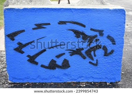 Black and blue eagle design on a cement block