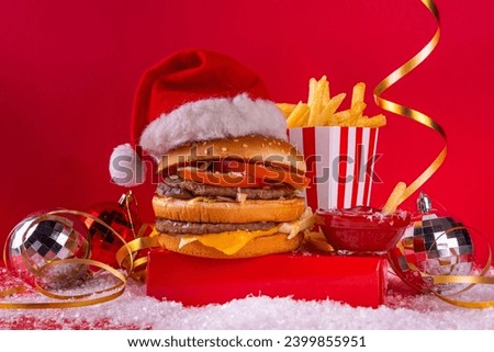 Christmas burger and french fries delivery menu. Big cheeseburger with french fries and ketchup sauce on festive Christmas and New Year decorated background