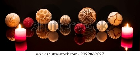 Wooden Christmas decorations with black reflection.