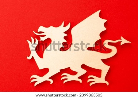 Wooden drakon on red background. Chinese horoscope, new year of the dragon 2024