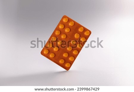Close-up of blister with tablets, daily dose of medication for person. White tablets in orange package. Prescription, recovery, medicine, health concept Royalty-Free Stock Photo #2399867429
