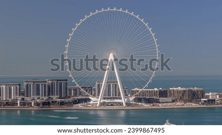 Bluewaters island with modern architecture and ferris wheel aerial. Yacht floating near by early morning. New leisure and residential area near Dubai marina and JBR area. Royalty-Free Stock Photo #2399867495