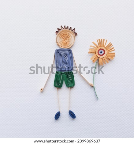 Simple colorful stick figure boy giving flower, love, Mother's Day, boy with blue shirt make in quilling art isolated on white background. Hand made of paper quilling technique. handicraft at home.