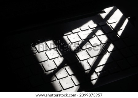 25.10.2023. Raiganj West Bengal India shadowy picture of laptop keyboard kept near window