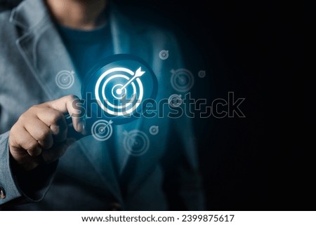 the realm of strategic leadership as a businessman's hand, magnifying glass in tow, guides you through the intricacies of goal setting, work schedules, and the achievement of organizational objectives Royalty-Free Stock Photo #2399875617