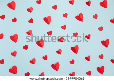Valentine day minimalist festive pattern of red hearts on pastel blue background top view. Flat lay style. Royalty-Free Stock Photo #2399904069