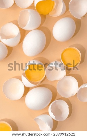 White eggs are distributed on the table. A broken eggshell. Royalty-Free Stock Photo #2399912621