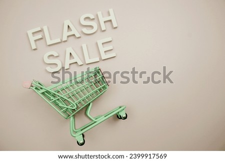 Flash sale alphabet letters andn trolley shopping cart on pink background