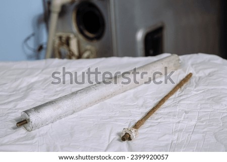 New and old used anode magnesium anodes for heating element of an electric water heater. Limited depth of field. Royalty-Free Stock Photo #2399920057