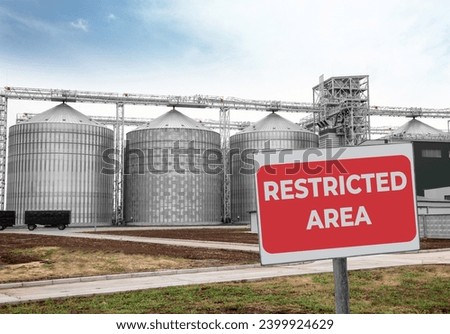 Sign with text Restricted Area near granaries outdoors