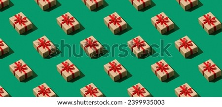 Pattern of wrapped gifts on a green background. Panoramic image. Holiday concept.