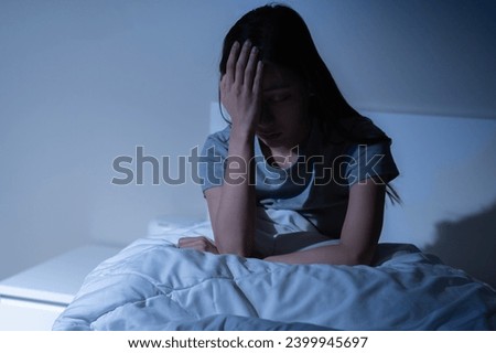 Sad worried and stressed, depressed asian young woman, girl suffering in bed from insomnia problem, awake at night, hand covering face from trouble disturbed loud noise, unable sleep. Restless people. Royalty-Free Stock Photo #2399945697