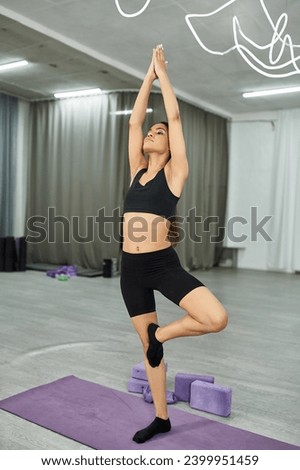 sportive african dancer standing in mountain pose while meditating and training in dance hall