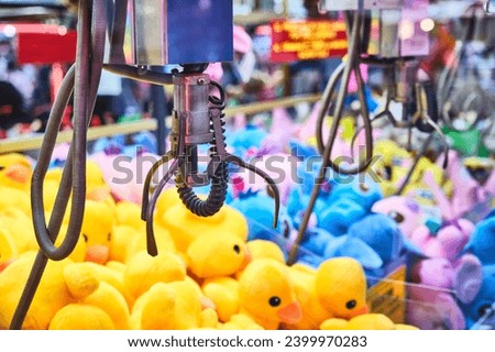 Fairground attraction that catches stuffed toys. Crane for catching stuffed toys Royalty-Free Stock Photo #2399970283
