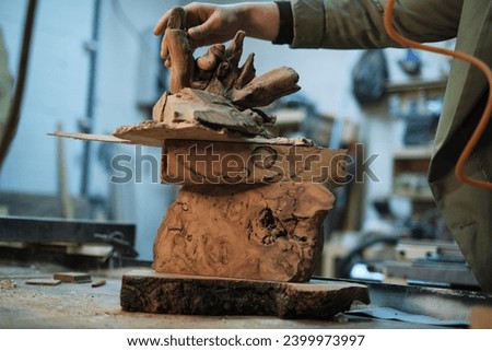 The natural curves and edges of burl wood are stacked in an artistic formation, evoking a sense of potential before the carving begins. Royalty-Free Stock Photo #2399973997