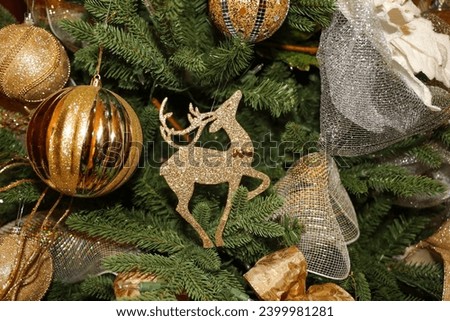 Christmas background with gold ornaments and decorations on pine tree.