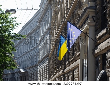 Flag of the European Union and Ukraine. Embassy of Ukraine. Flag of the country. International organization. A democratic country. Royalty-Free Stock Photo #2399981297