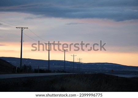 road into sunset with electric poles