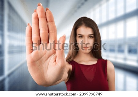 Young woman show stop sign with hand