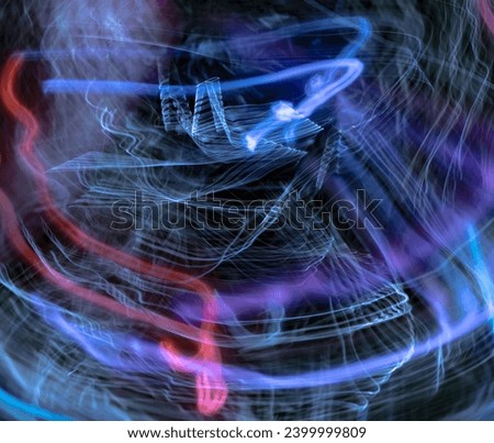 blurred electrical red, maroon, violet, black, purple, silver and blue waves on dark sky background