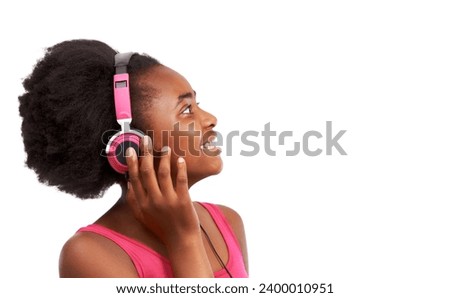Headphones, happy and young black girl in a studio listening to music, album or playlist. Smile, teenager and gen z African child model streaming a podcast, song or radio by white background.