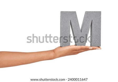 Woman, hand and letter M or font in studio for advertising, learning or teaching on mock up. Sign, alphabet or character for reading, text or communication and grammar or symbol on white background