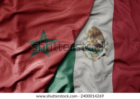 big waving national colorful flag of mexico and national flag of morocco . macro