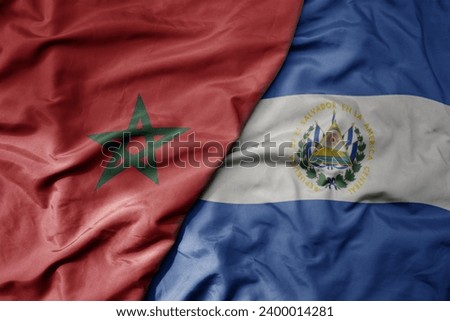 big waving national colorful flag of el salvador and national flag of morocco . macro