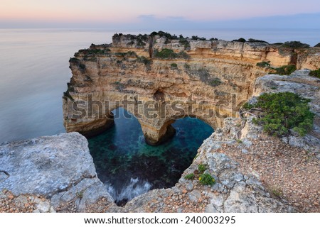 Romantic place with a heart carved in the rock, perfect to enjoy Valentine's Day. Marinha Beach has an amazing landscape, and is one of the main attractions of the Algarve. Royalty-Free Stock Photo #240003295