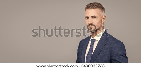 mature man with grizzled hair in formal suit copy space, formal. Man face portrait, banner with copy space. Royalty-Free Stock Photo #2400035763