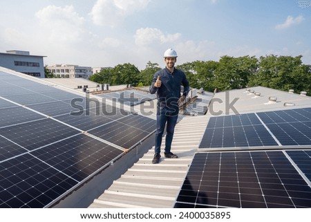 Engineer service check installation solar cell on the roof of factory. Silhouette technician inspection and repair solar cell on the roof of factory. Technology solar energy renewable.