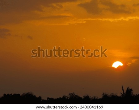 dusky view of the setting sun during sunset in the evening Royalty-Free Stock Photo #2400041169