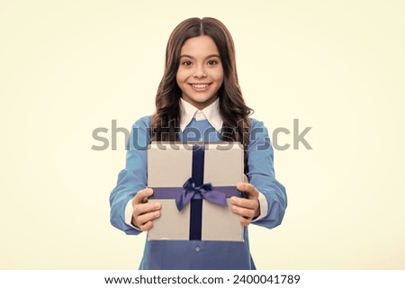 Young teenager girl child holding gift box isolated on white background. Gift for kids birthday.