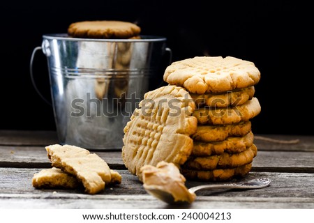 shortbread cookie with peanut butter on a black background Royalty-Free Stock Photo #240004213