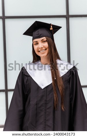 Female high school graduate modeling her cap and gown. Class of 2023.