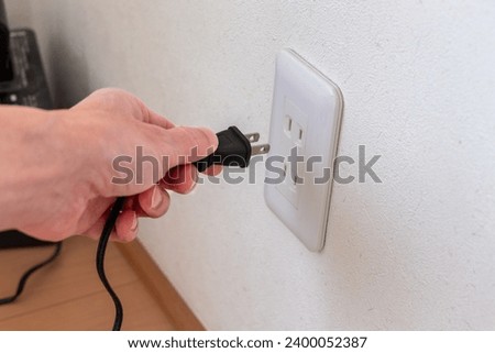 Wall outlet and equipment power plug Royalty-Free Stock Photo #2400052387