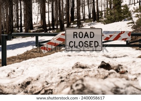 Road closed sign and gate in spring.