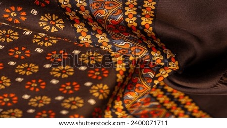 silk fabric of brown color with red and yellow colors, dense fabric, double-sided based on triacetate fibers. Background, Pattern Decor Royalty-Free Stock Photo #2400071711