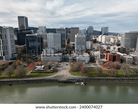 Aerial drone shot of downtown Portland, Salmon Street Springs, Tom McCall Waterfront park and the Willamette River on an overcast day in November