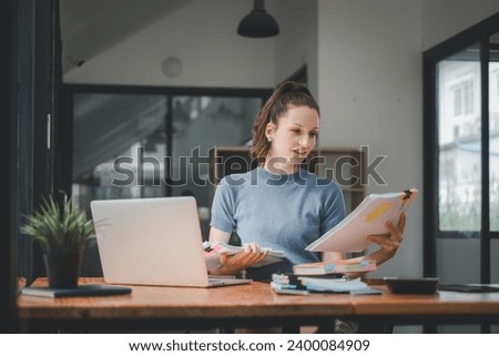 Business woman manager accounting analyst checking bills, analyzing sales statistics management, taxes financial data documents or marketing report papers working in office using