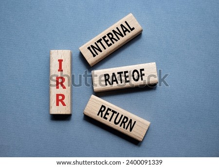 IRR - Internal Rate of Return symbol. Concept word IRR on wooden cubes. Beautiful grey background. Business and IRR concept. Copy space.
