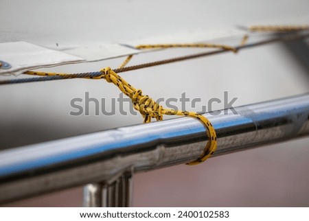 rope ties the tarpaulin to the metal frame