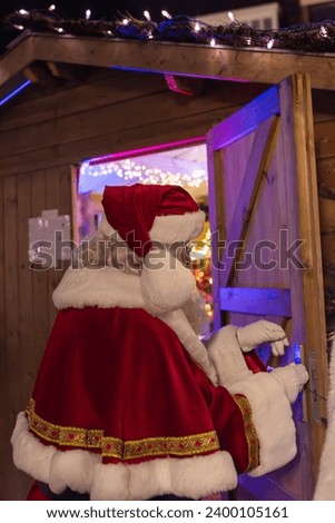 Santa Claus on the background of a wooden house