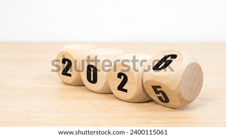 Wooden 2025 to 2026 new year white background. 
Word 2025 - 2026 wood cube on wooden desk for copy space.  Royalty-Free Stock Photo #2400115061
