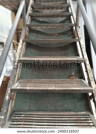 Rusty, unsafe staircase - a perilous climb. Urgent repairs needed for enhanced safety and functionality.