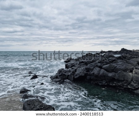 
This is a Jeju Island beach with basalt rocks. Royalty-Free Stock Photo #2400118513