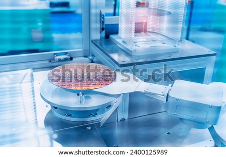 automate robot arm with silicon wafers and microcircuits and Automation system control application in smart factory Royalty-Free Stock Photo #2400125989
