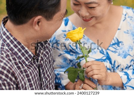 Elderly Asian couple having romantic date in local park