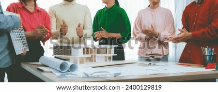 Professional interior designer team clapping hand to celebrate their successful project while project manager presents their main theme color. Creative design and teamwork concept. Variegated.